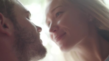 Young woman looks at man with love and then suddenly punish him biting his nose close up slow motion. Craziness in love friendship playing affection family life concept