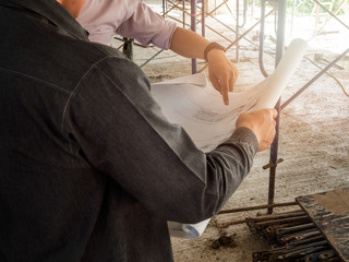 Fototapeta premium Engineer discussing with foreman about project in building construction site