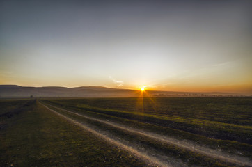 Scenic view of mountains, autumn or winter landscape with colorful hills at sunset. Yellow meadows and snowy mountains of Azerbaijan Big Caucasus. Gabala Sheki