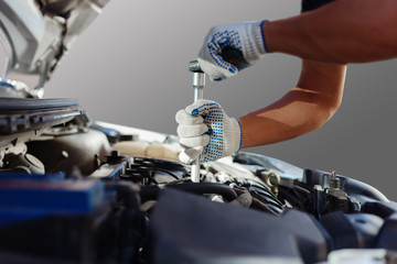 Mechanic working in auto repair garage. Car maintenance