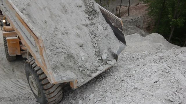 Large Truck Unloads Calcareous Rock