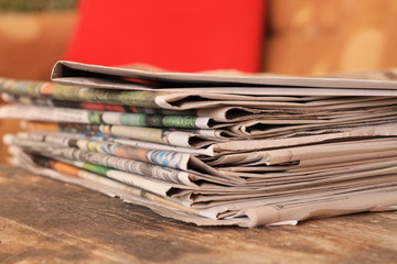 Newspapers on wooden table 