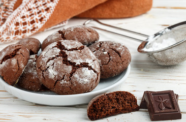 Homemade chocolate cookies with cracks. Biscuits with icing sugar.  Selective focus
