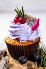 Chocolate cupcakes.Cupcakes with berries,fruit,strawberries. Top view.colorful cupcake,tasty cake,colorful cream,candies,cupcakes with summer berries on wooden background,close up,dessert concept