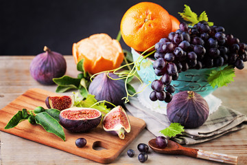Healthy Food Background with Colorful Fruit. Grape, Orange, Figs