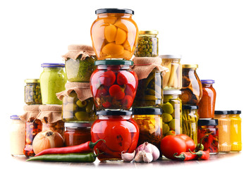 Jars with variety of pickled vegetables  isolated on white