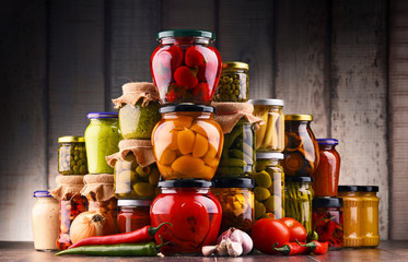 Jars with variety of pickled vegetables.