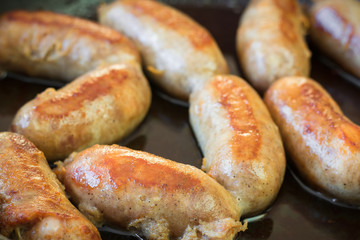 Homemade sausages fried in oil in skvorode.
