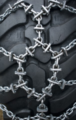 snow chain on a tire for tractors, used to clean the streets of snow after a snowfall, Trentino Alto Adige, Italy