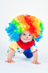 Child clown with a red nose multicolored wig in with balls