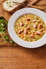Bowl of Creamy Pea Soup with Chopped Sausage