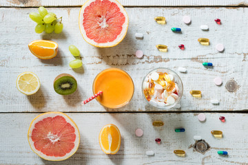 Healthy lifestyle and diet concept. Fruit, pills and vitamin supplements, flatlay