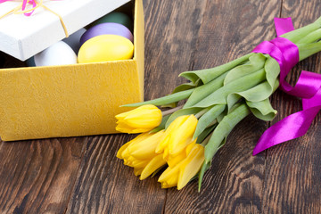 Colorful Easter Eggs and tulips decorated in beautiful giftbox