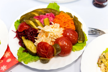 Serve canned vegetables laid out on plate: tomato, cucumber, cabbage, beets, carrots. How to preserve the taste and benefits of favorite vegetables for the winter.