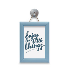 Enjoy the little things - motivational quote. Stylized lettering. Blue wooden frame