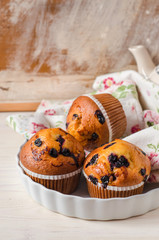 Blueberry muffins on wooden vintage background. Selective focus