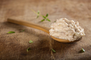 Spoon filled with creamy paste made from tone fish, butter and onion