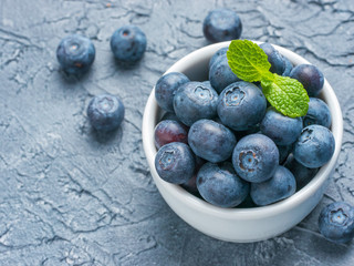 Blueberries in spoon on dark background
