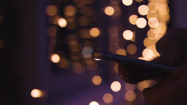 Closeup of young man hands typing sms scrolling pictures phone