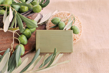 Basket with olives , soap bar on burlap 