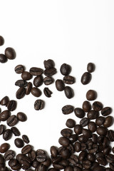 Background of several coffee beans on white background. Texture. Vertical shoot.