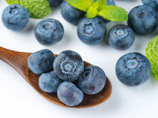 Blueberries in spoon on dark background