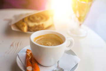 Coffee and rolls on the table.