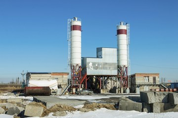 Exterior view of a cement factory. Concrete mixing silo, site construction facilities.