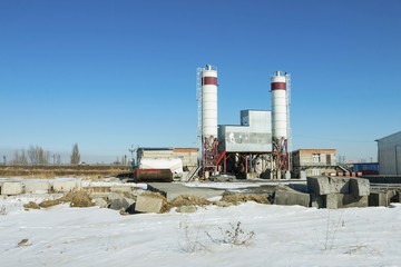 Exterior view of a cement factory. Concrete mixing silo, site construction facilities.