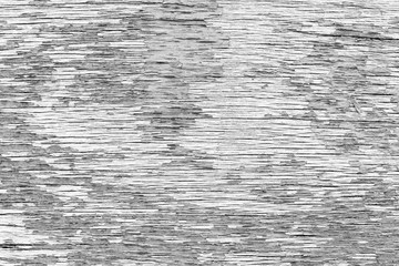 Close-up of a cracked and weathered plywood texture background with paint peeled off in black&white.