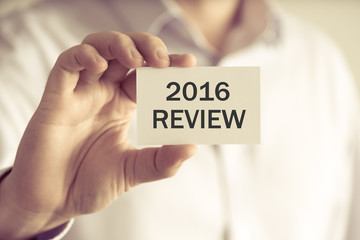 Businessman holding 2016 REVIEW message card