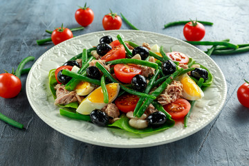 Fresh Tuna Green Bean salad with eggs, tomatoes, beans, olives on white plate. concept healthy food