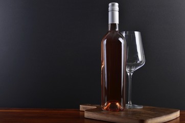 Fototapeta na wymiar Rose wine on board with glass