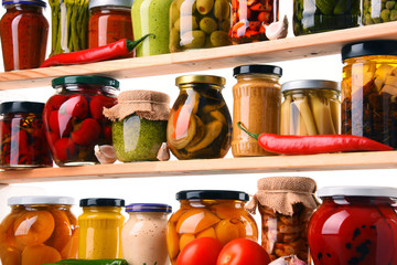 Jars with variety of pickled vegetables.