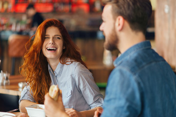 Friends talking and having fun at dinner party.