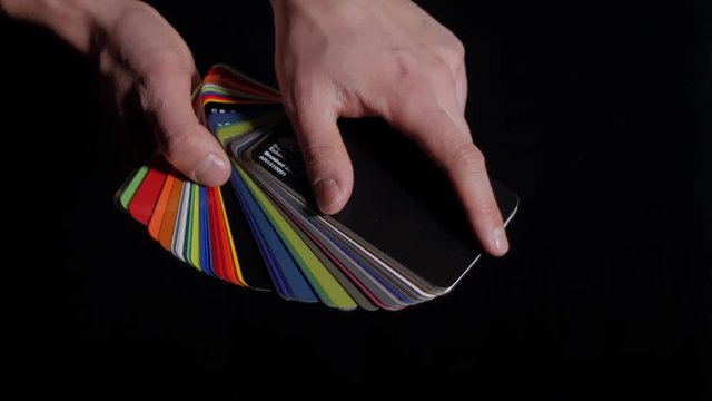 Color sampler for exterior vinyl siding isolated on black, desinger hands