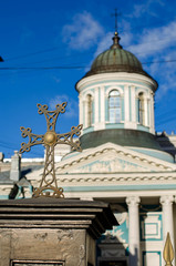 Fototapeta na wymiar Cross closeup on background of the Armenian Church in St. Petersburg. Russia.