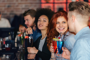 Friends drinking cocktail in bar