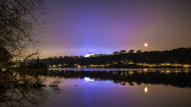 Time Lapse of tranquil lake in Stockholm at night. Ericsson Globe in the background