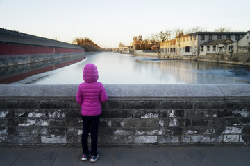Child looking at river in Forbidden City