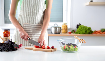 Fresh vegetables on the cutting board, salad in a glass dish. Concept of cooking