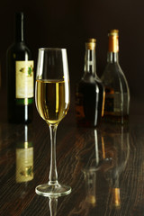 Two Glass of wine, brandy or cognac on the mirror wooden table