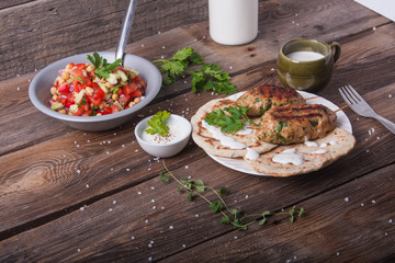 Kofta with flatbread on plate with salad