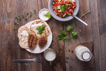 Kofta with flatbread on plate with salad