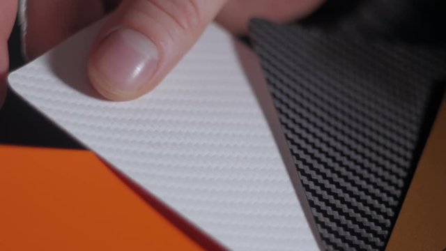 Color sampler for exterior vinyl siding isolated on black, desinger hands