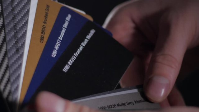 Color sampler for exterior vinyl siding isolated on black, desinger hands