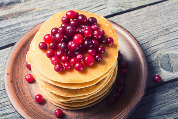 A stack of pancakes with cranberries