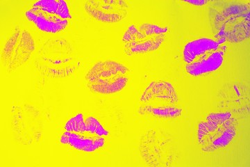 Naklejka premium Abstract purple lipstick kisses on yellow art background