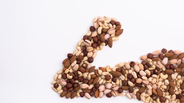 Arm of a bodybuilder made from different nuts. Imitation of pumping muscles built with the help of nuts. Stop motion