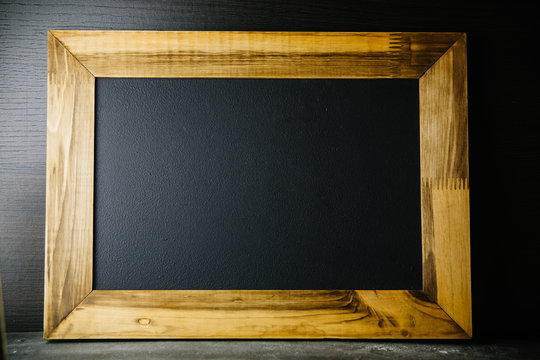 Wooden frame mock-up on black background.